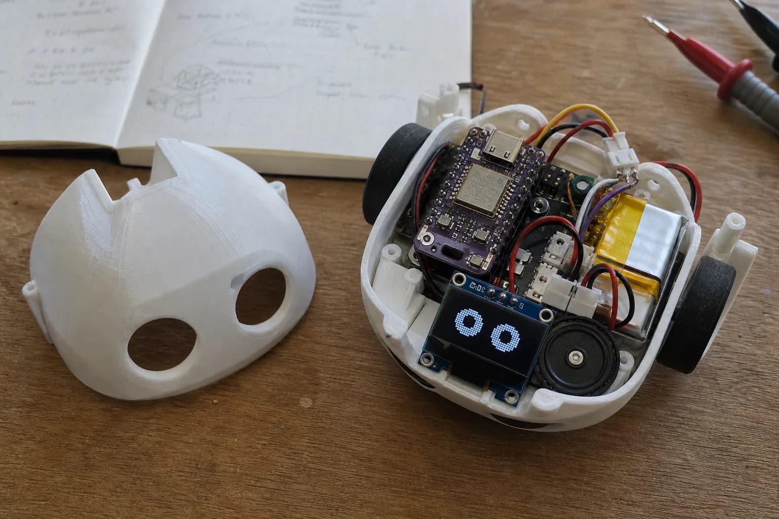 Original open robot prototype showing its controller, speaker, battery and display hardware